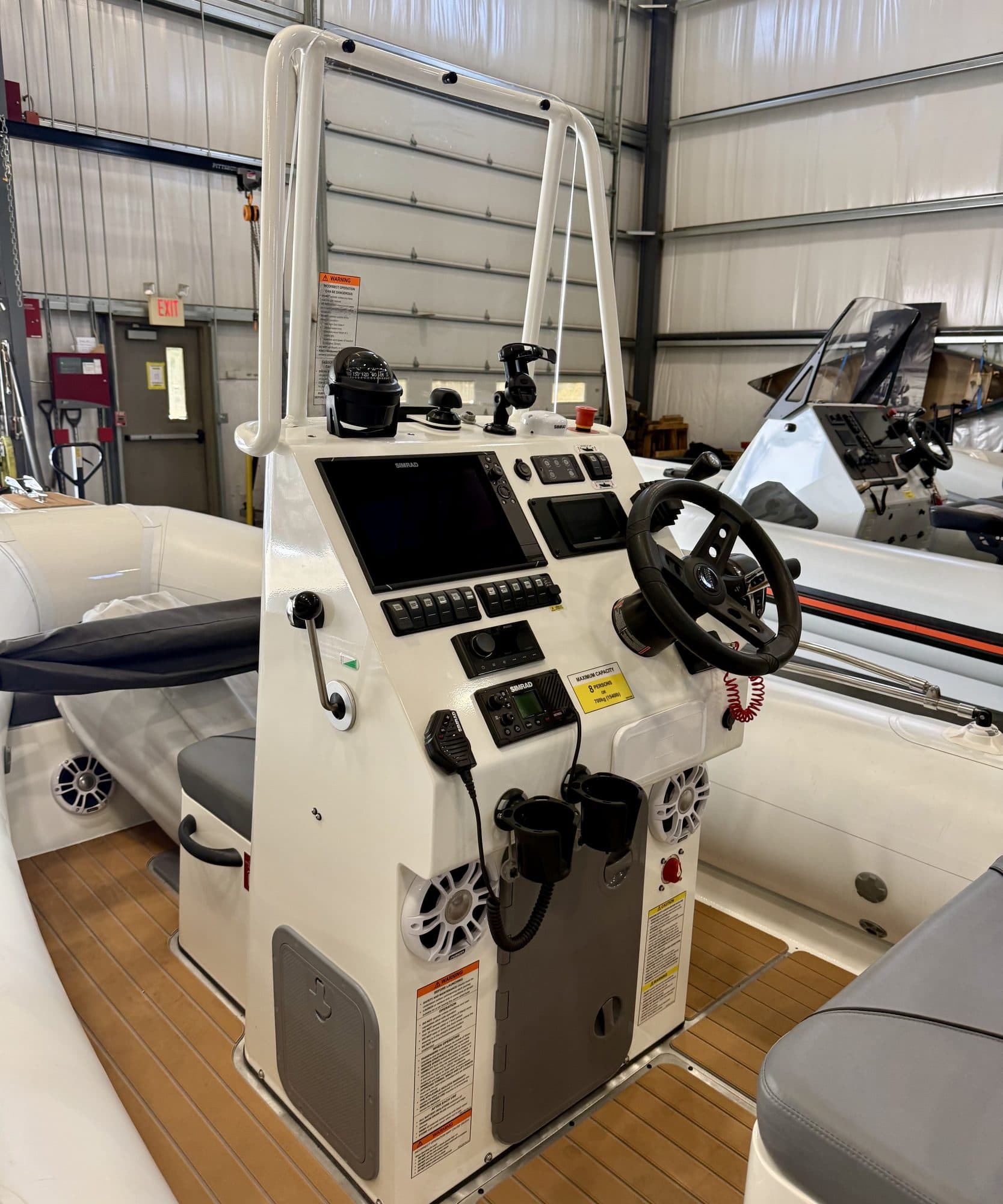 The helm console of a Sealegs RIB, wheel and throttle, inside the Bristol workshop